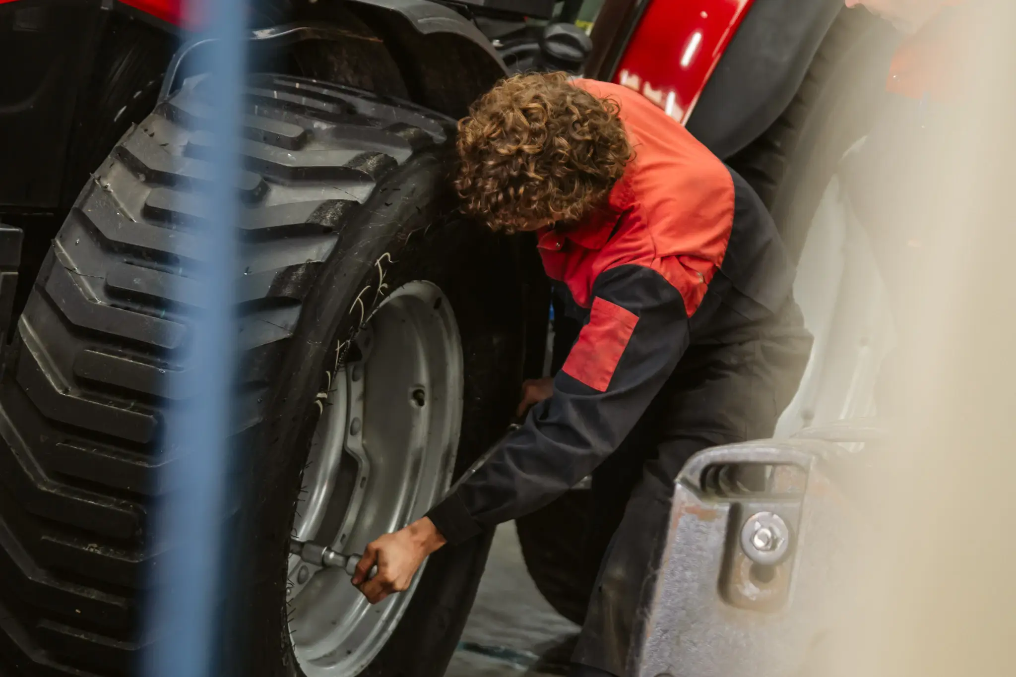 Een monteur werkt aan het wiel van een machine